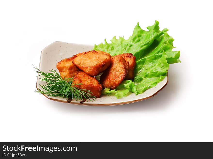 Fried meat with salad and dill in squared plate over white background