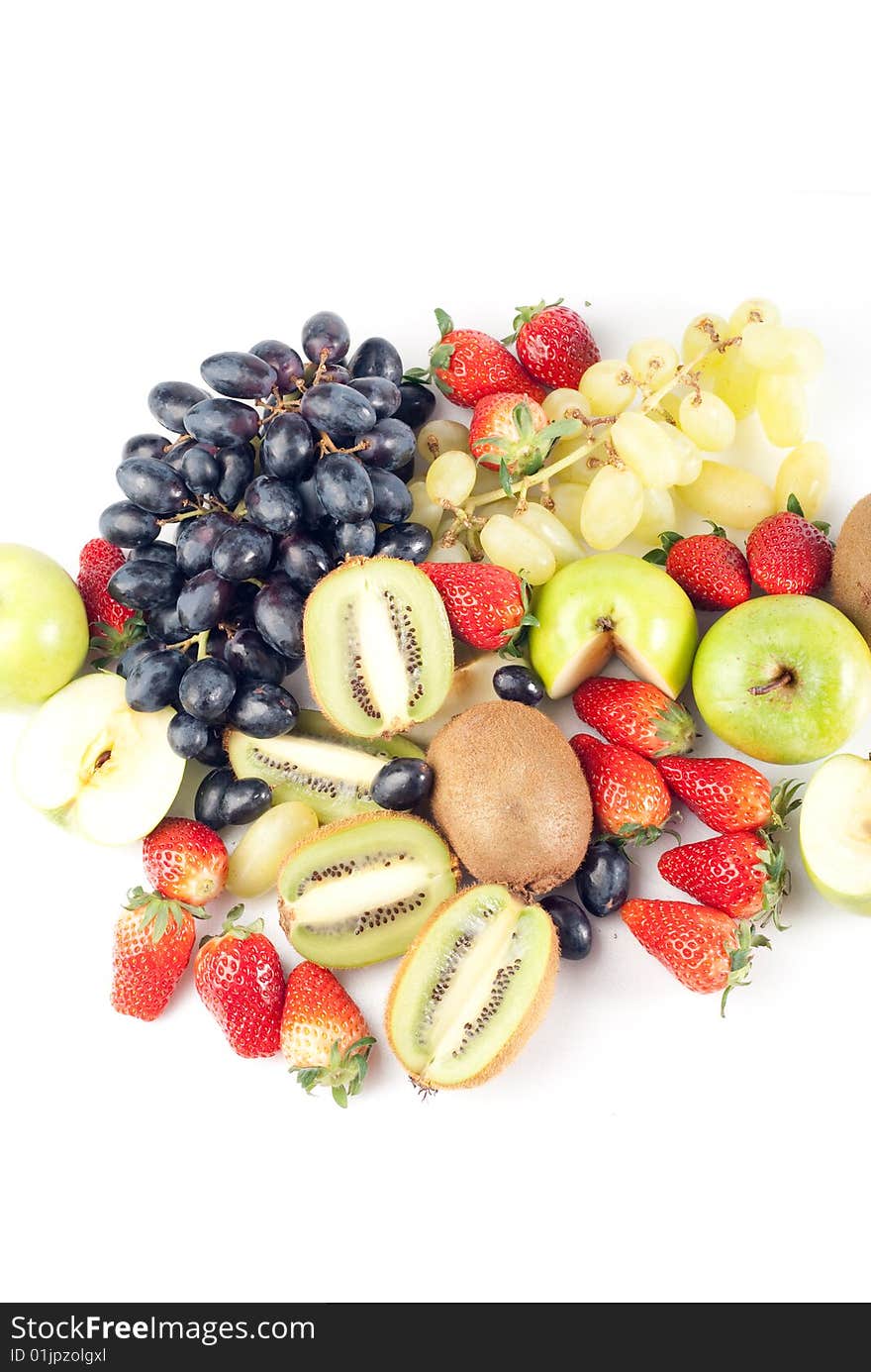 Assorted fresh fruits background including strawberry, apple, kiwi and black and green grape