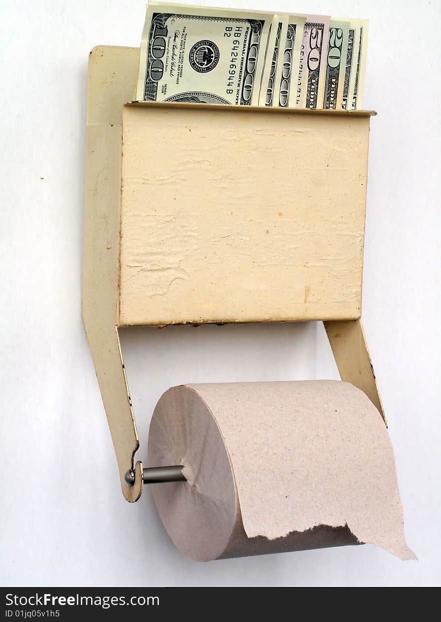 US dollars held in a tiolet paper dispenser. US dollars held in a tiolet paper dispenser