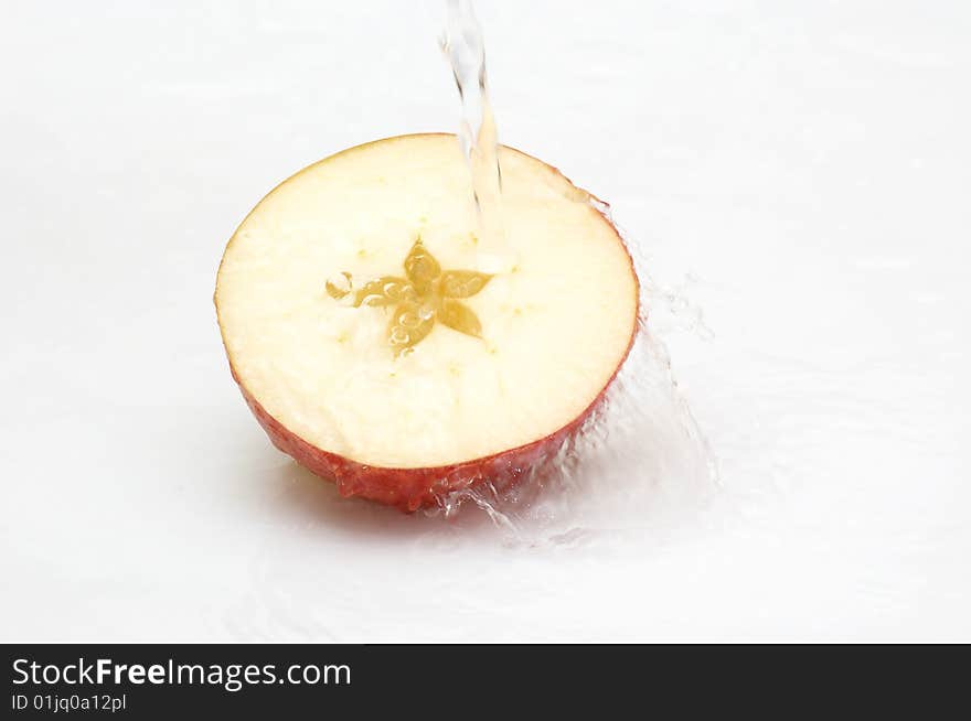 Crystal, Clean Water Splashing On An  Ripe Apple.