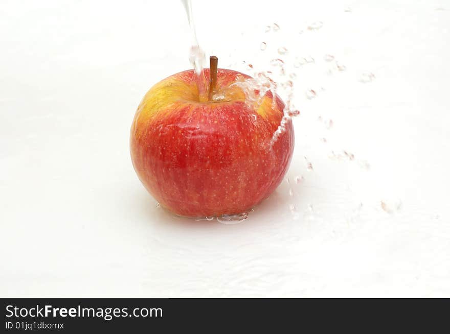 Apple splashing in  cool water.