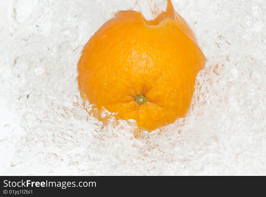 Fresh,juicy orange splashing in cool,clean water.