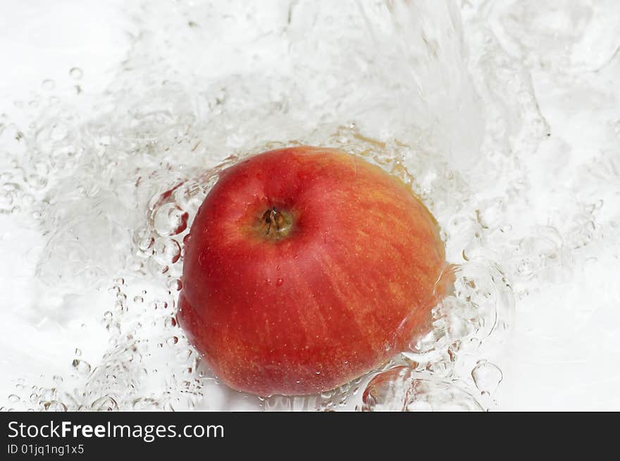 Water splashing on an apple. Water splashing on an apple.