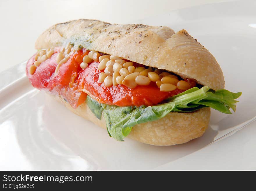 Sandwich with a salmon on a white plate