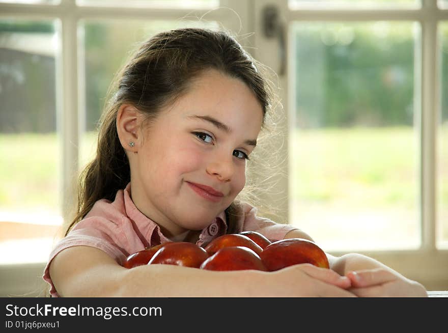 Brown Haired Child Holding Apples