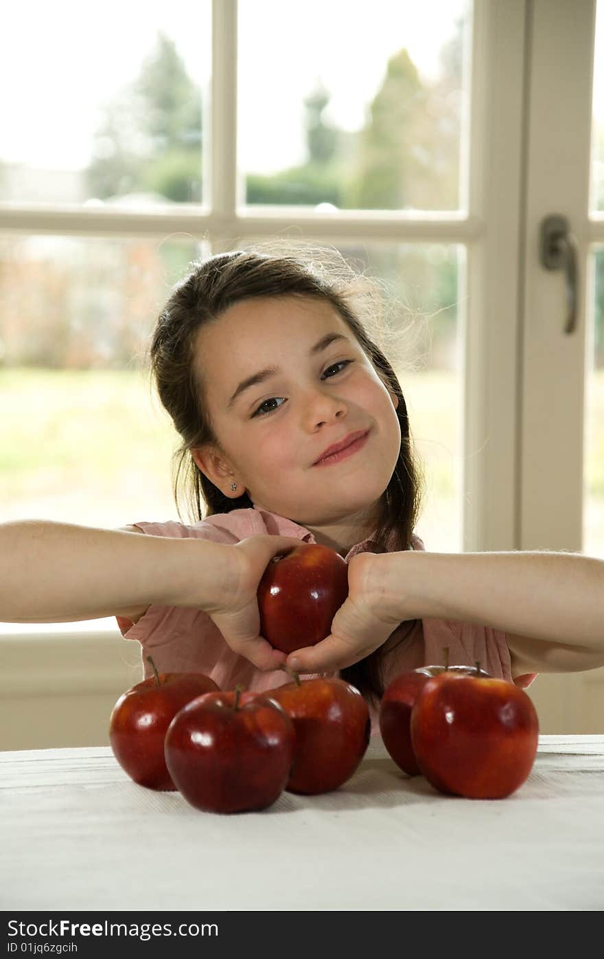 Brown Haired Child Holding An Apple