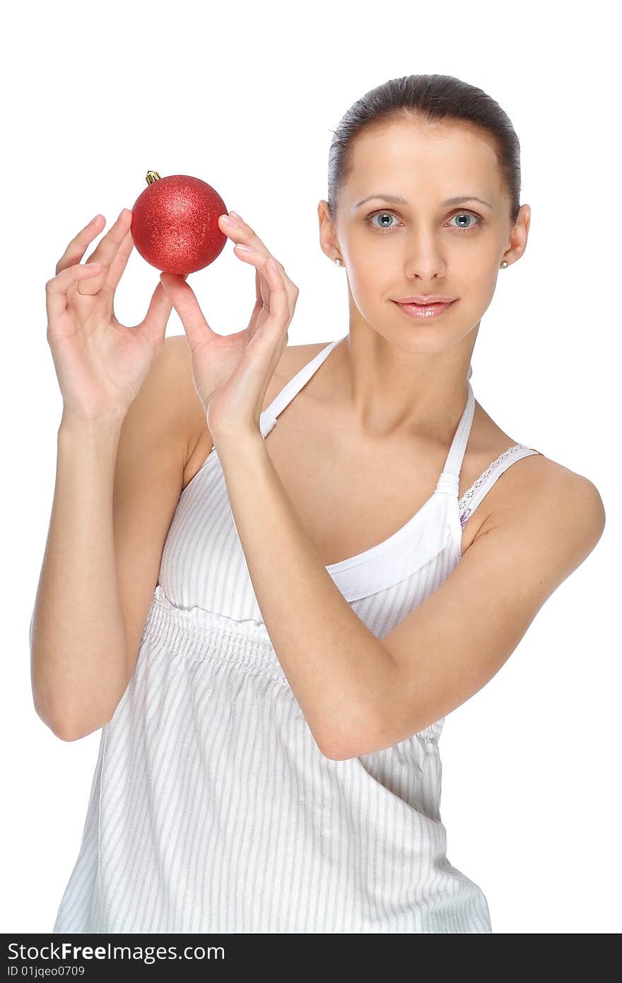 The woman holds a fur-tree toy in a hand. The woman holds a fur-tree toy in a hand