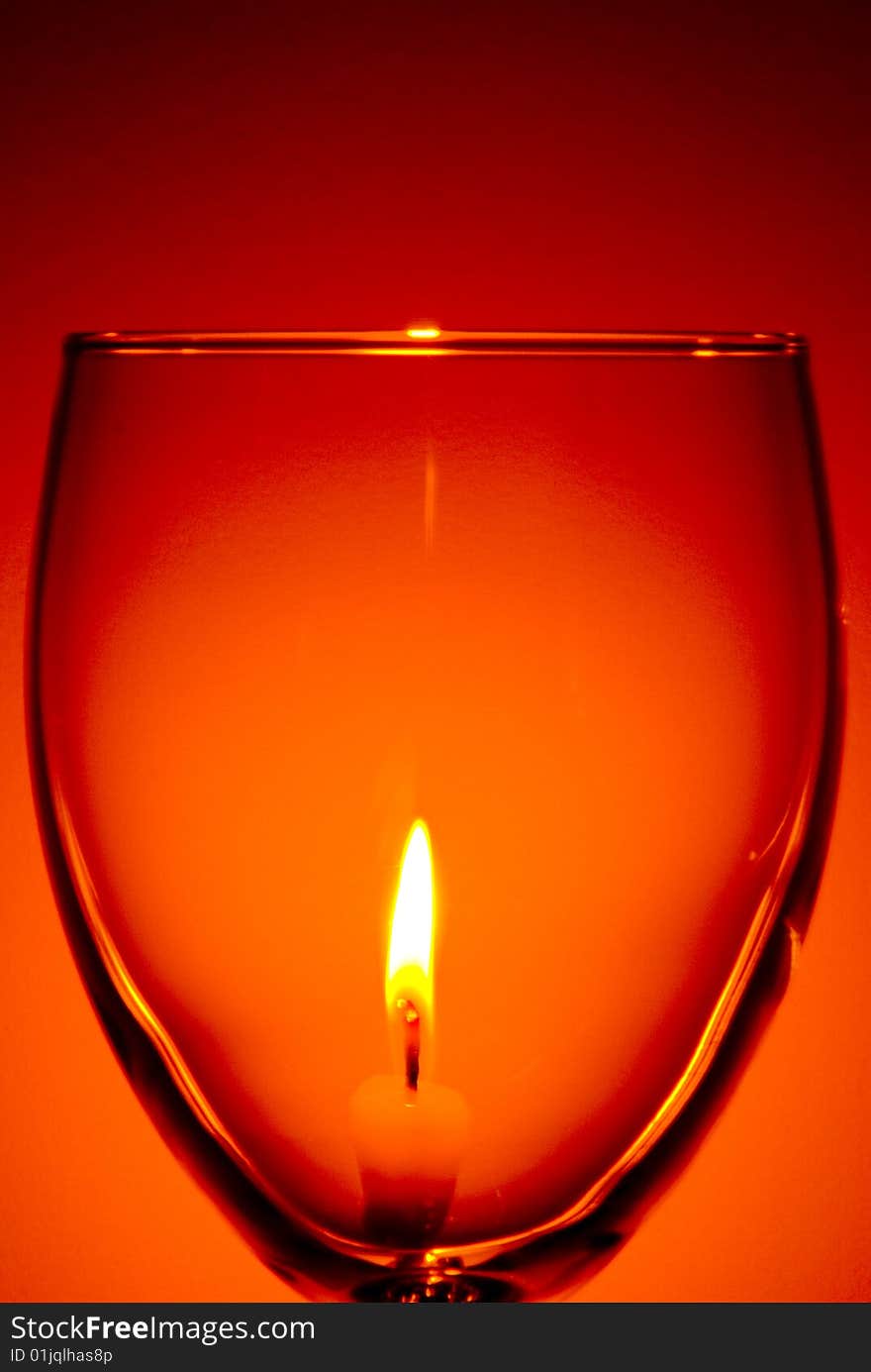 Lit Candle Through Wine Glass