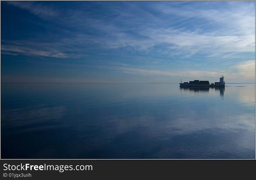 Ship filmed at sunset in Baltic sea going between sea and blue sky