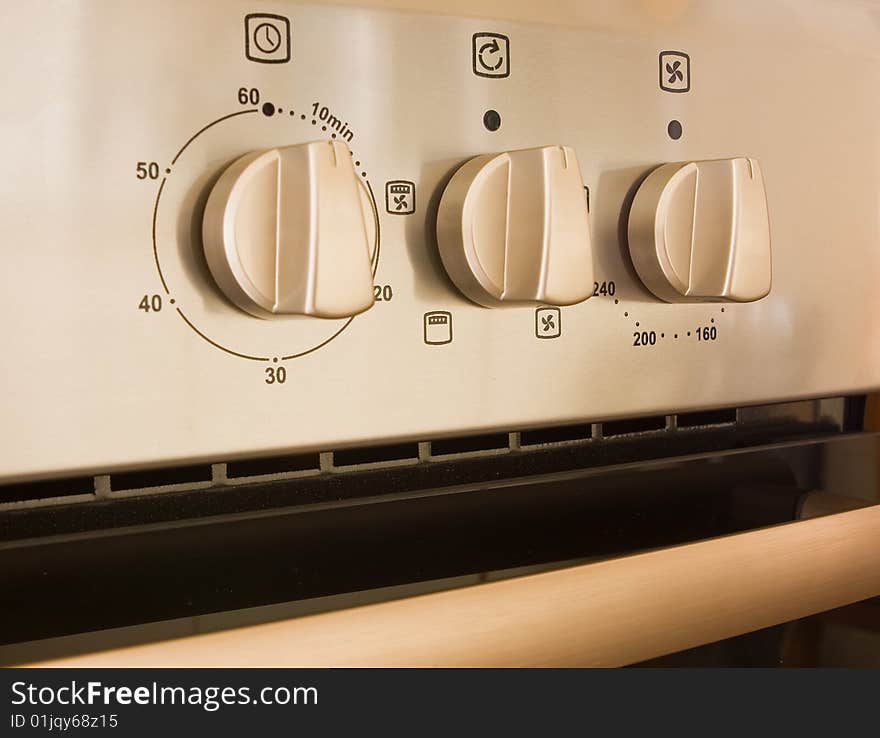 Controls on a modern cooker made of stainless steel. Controls on a modern cooker made of stainless steel