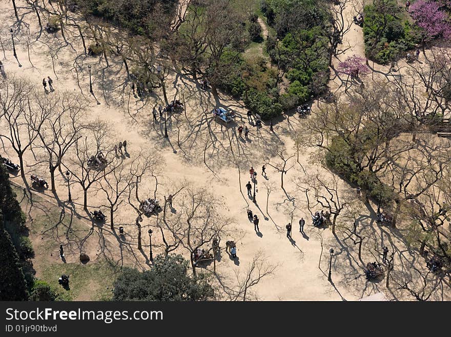 Birds eye view of people taking a walk in the park on a sunny day in early spring.