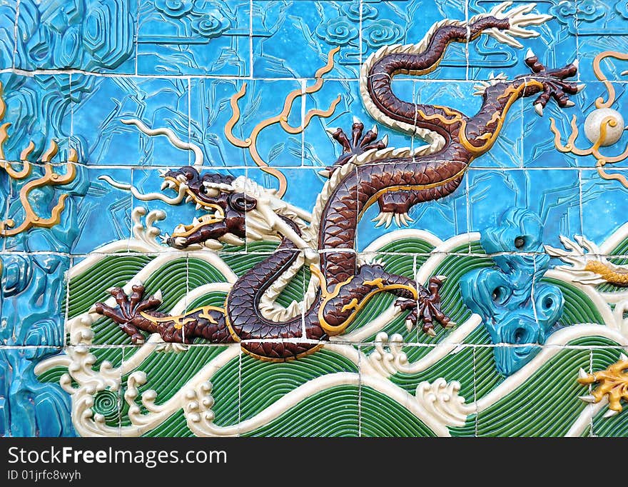 Traditional detail of a chinese ceramic dragon on the palace wall. Traditional detail of a chinese ceramic dragon on the palace wall.