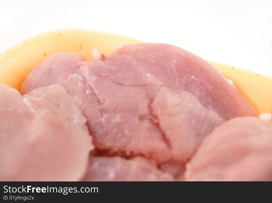 Raw turkey breast on the white plate