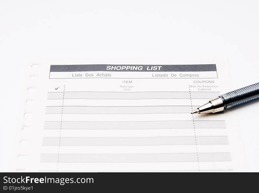 Shoping list with pen isolated on a white background