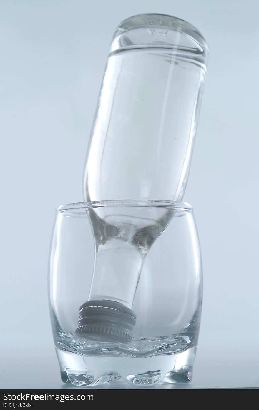 Bottle inside glass