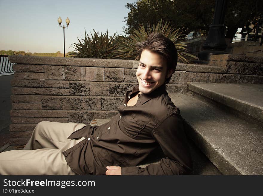 Young adult relaxing on concrete steps. Young adult relaxing on concrete steps