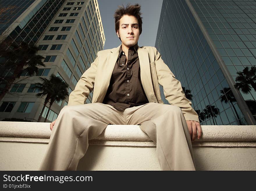 Businessman sitting on a ledge