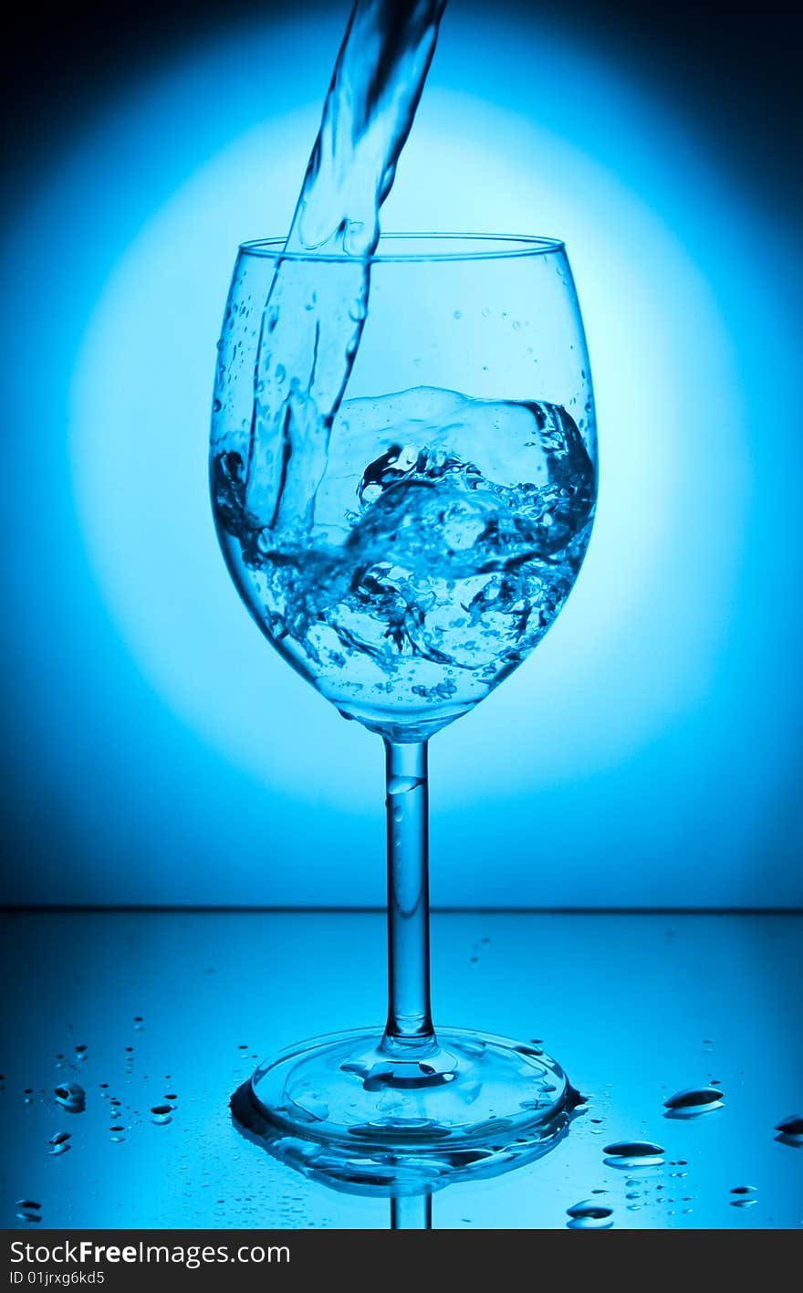 Glass with water on a blue background