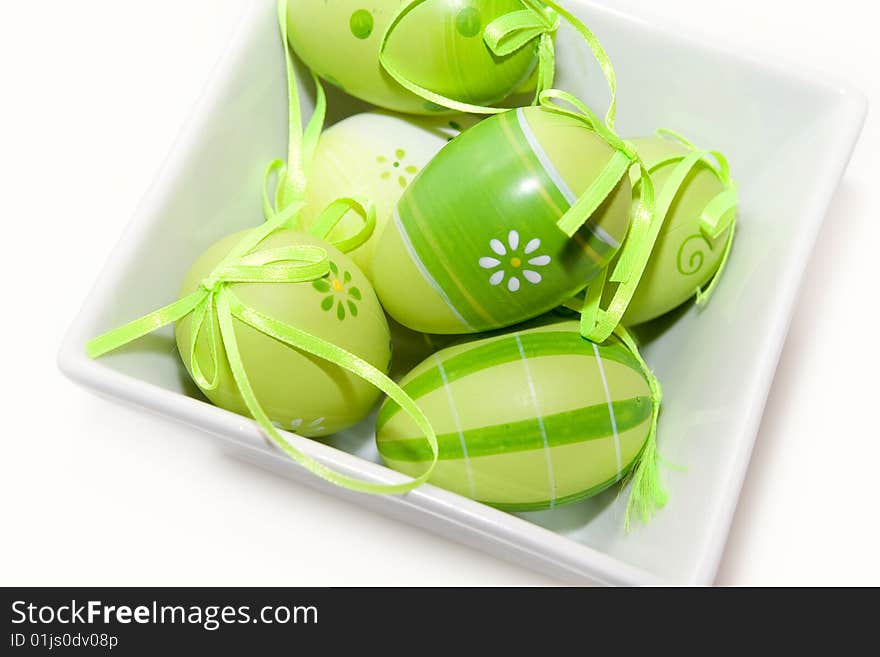 Easter eggs isolated on white in white bowl