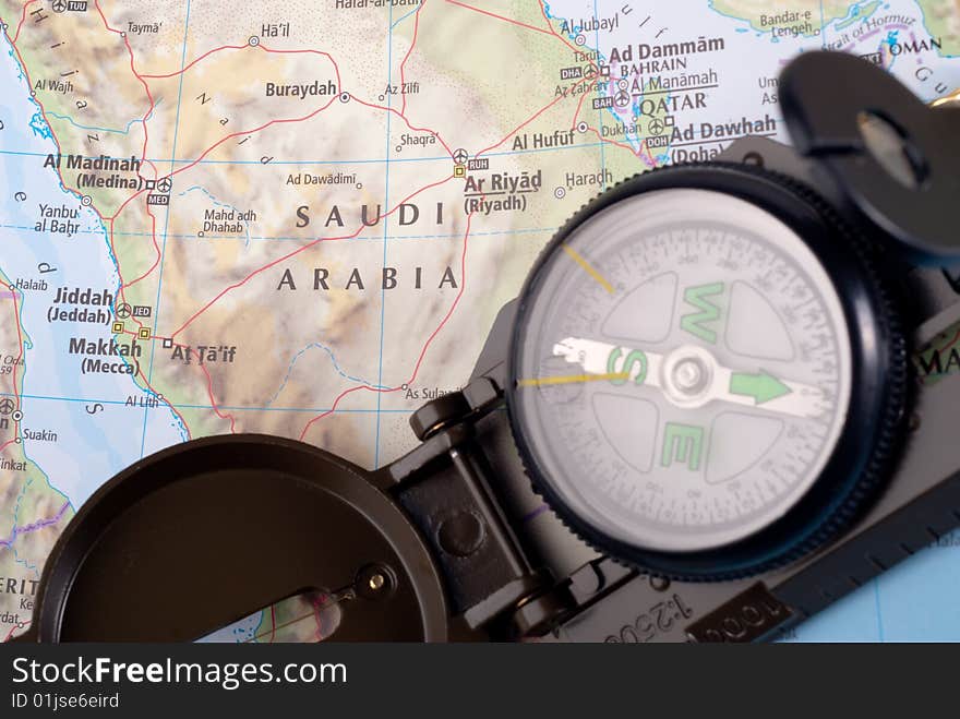 Steel compass on travel map of Saudi Arabia. Steel compass on travel map of Saudi Arabia