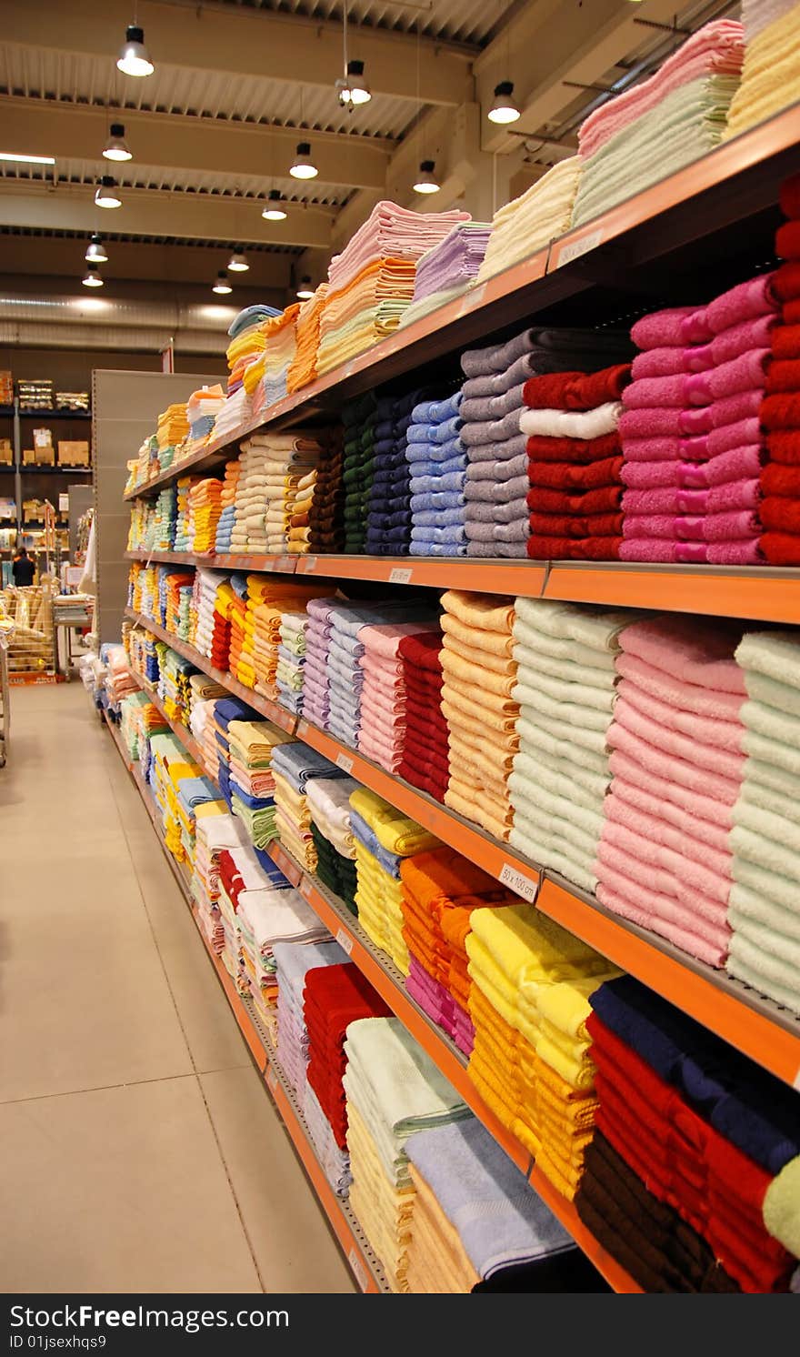 New colorful towels stacks on shelves in store