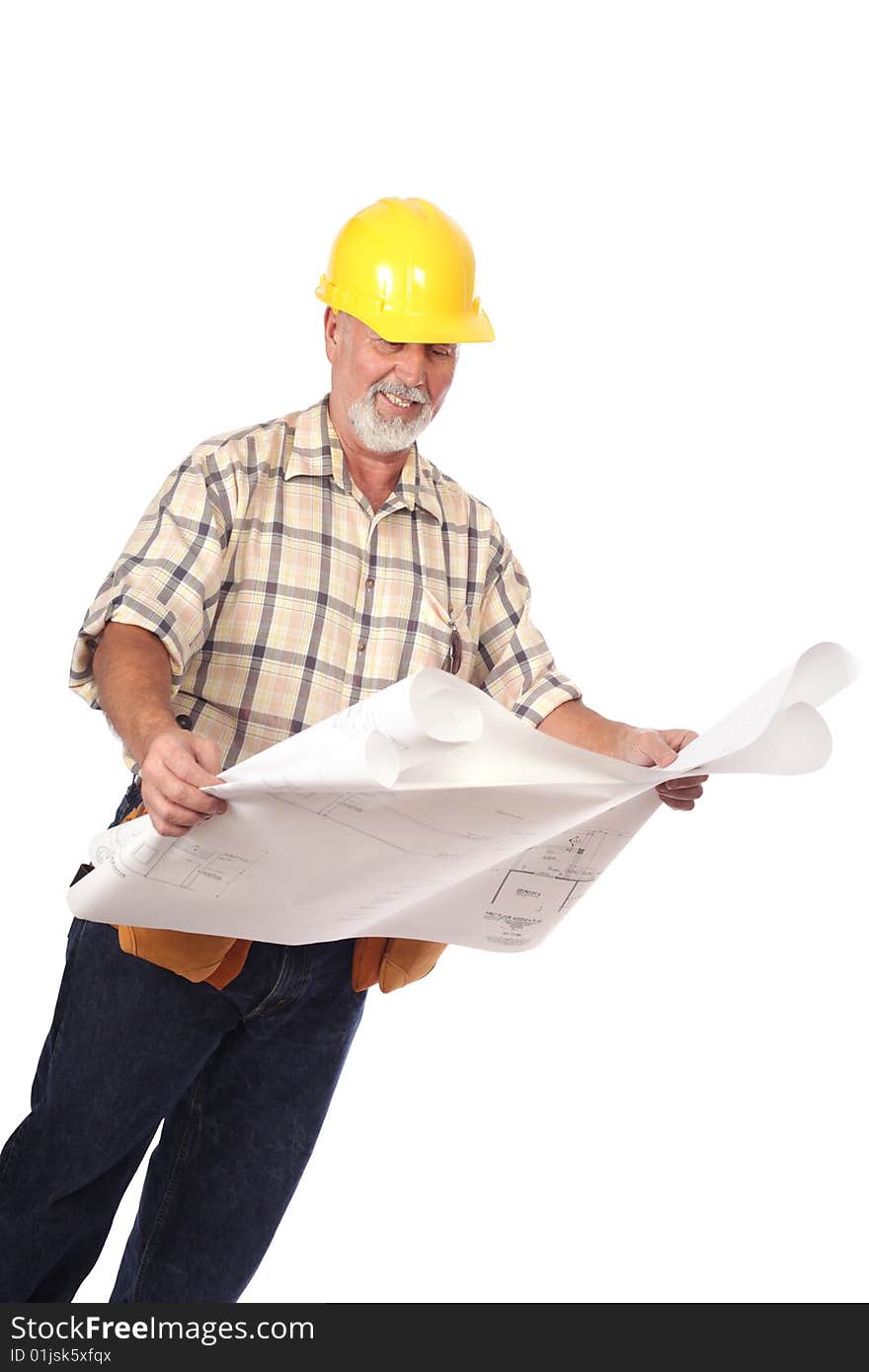 Construction worker in a tool belt and hardhat analyzing blueprints. Construction worker in a tool belt and hardhat analyzing blueprints