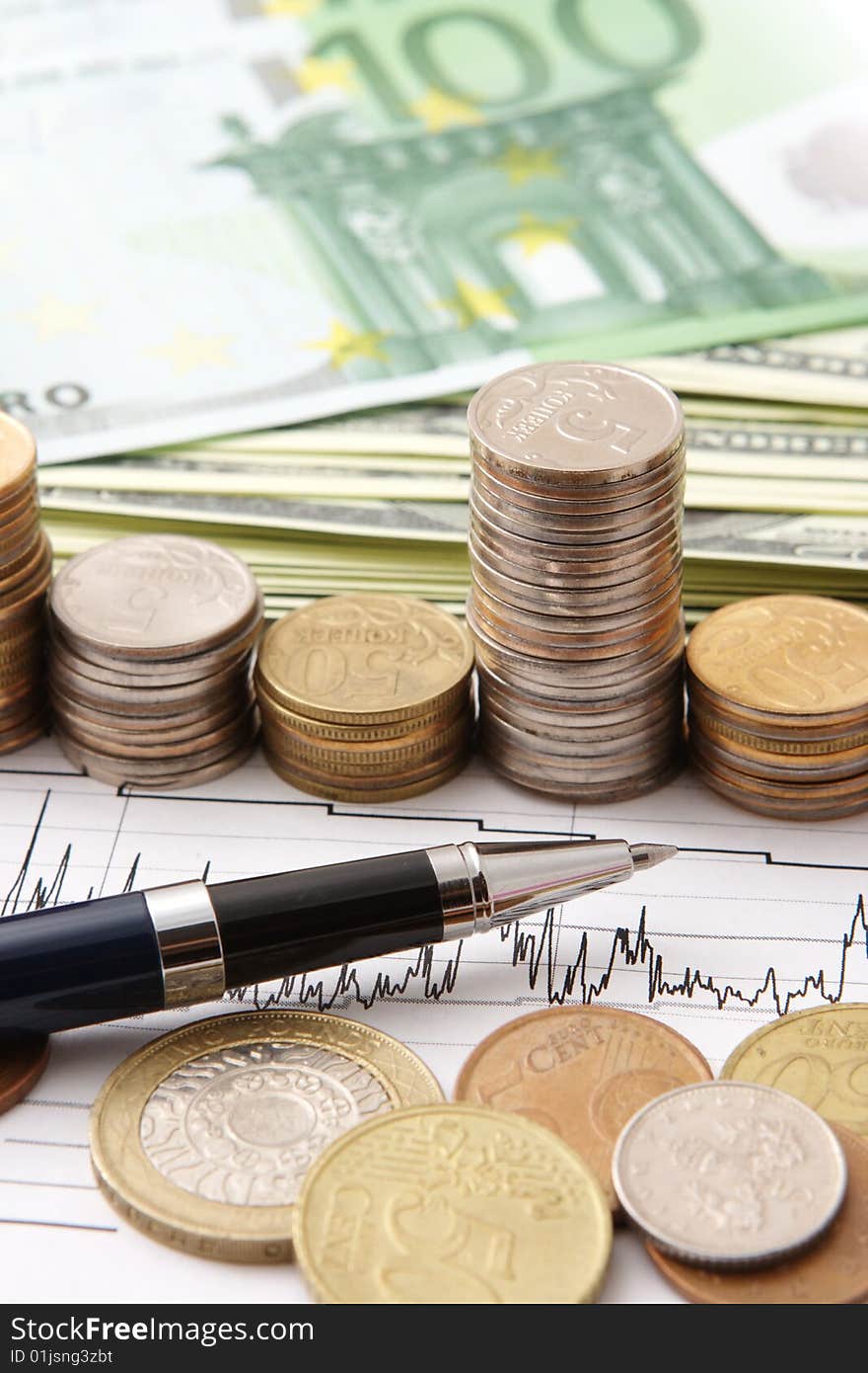 Close up of coins and pen on a graph. Close up of coins and pen on a graph