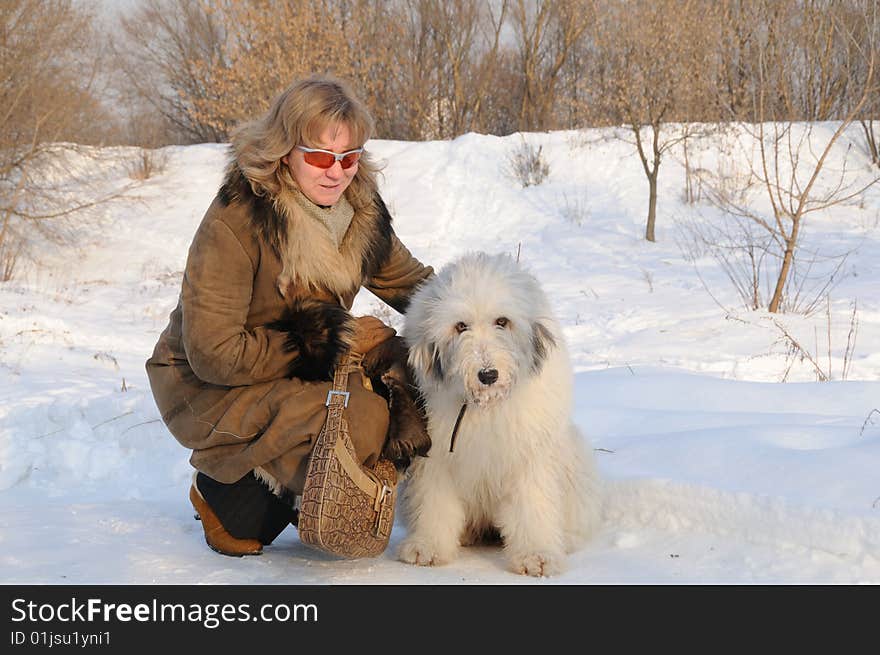 Women and puppy south russian sheep dog in winter park. Women and puppy south russian sheep dog in winter park