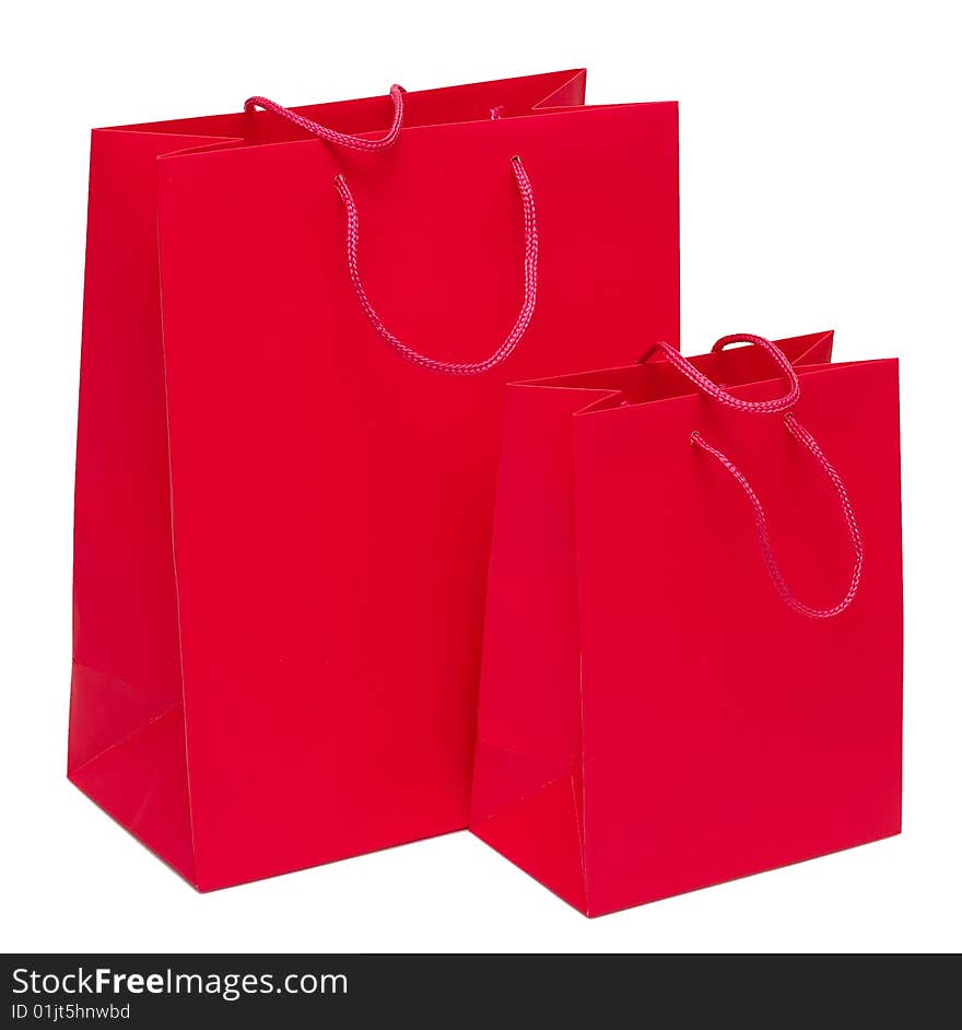 Two red paper bags for shopping on a white background. Studio work. Two red paper bags for shopping on a white background. Studio work.