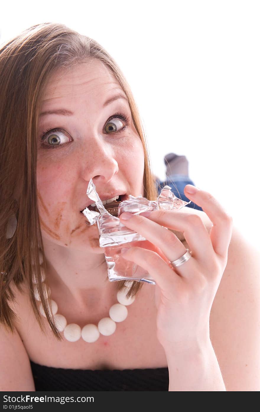 Closeup portrait of woman eating a chocolate. Isolated. Closeup portrait of woman eating a chocolate. Isolated