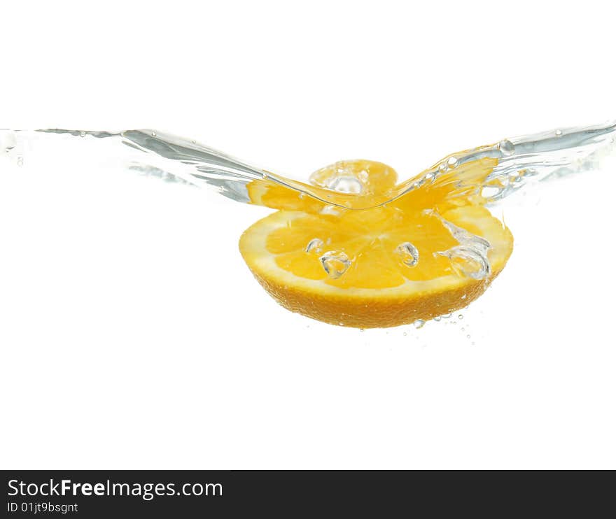 Orange falling into water isolated on white background