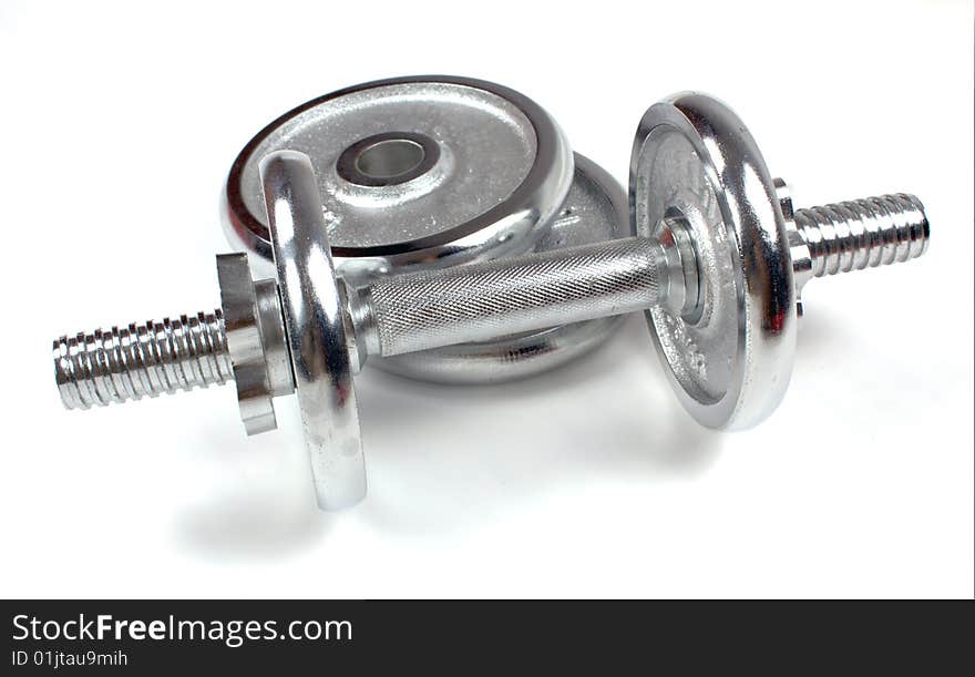 A metal dumbbell isolated on a white background, with shadow