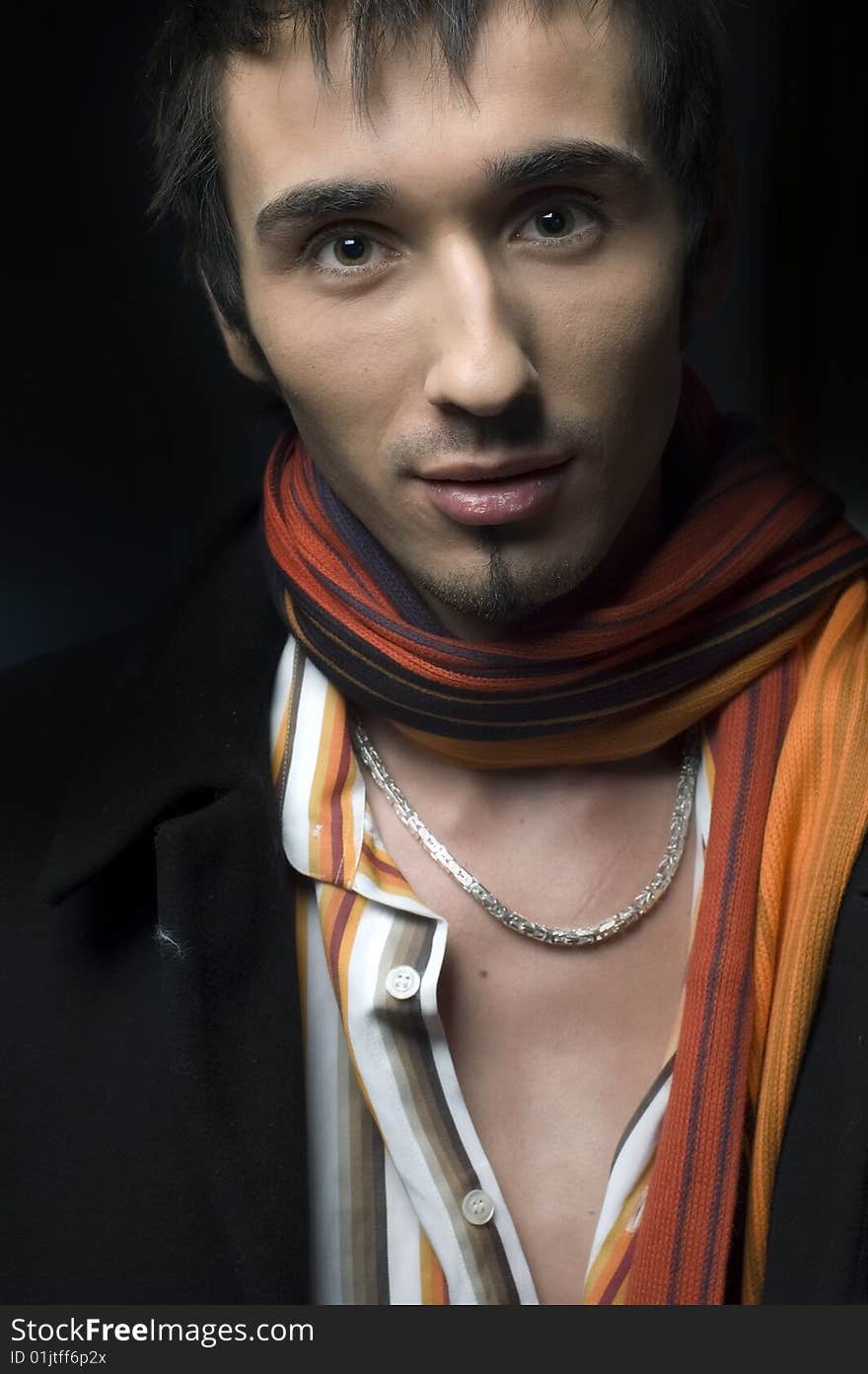 Portrait of a young business man with his hands on a dark background. Portrait of a young business man with his hands on a dark background