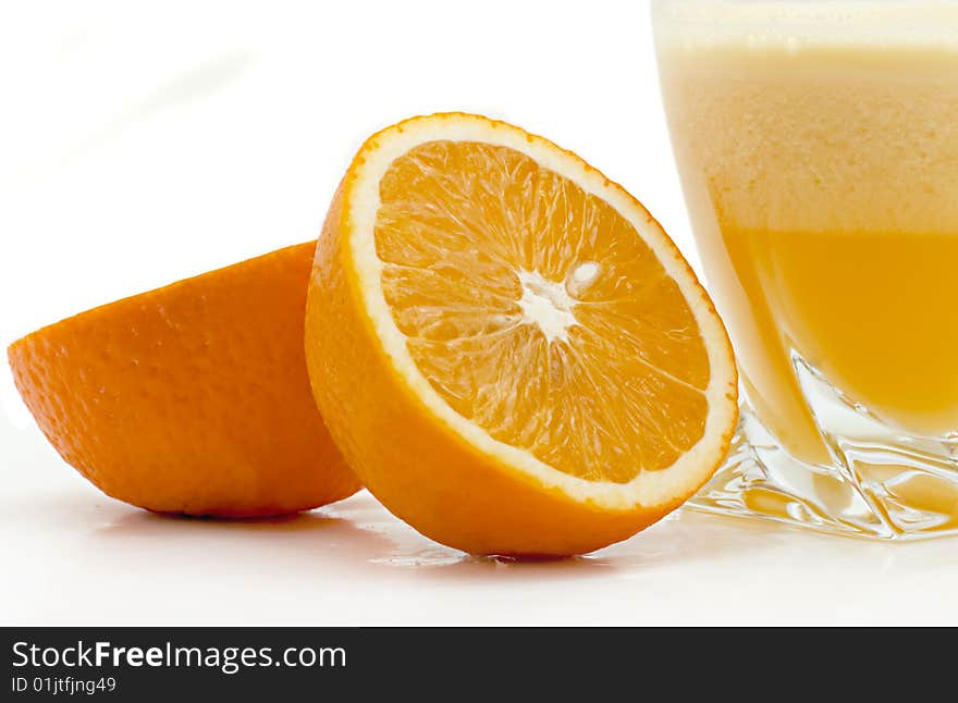 Glass of orange juice and oranges on a white background