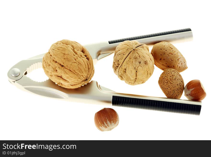 Nutcracker and nuts on a white background. Nutcracker and nuts on a white background.