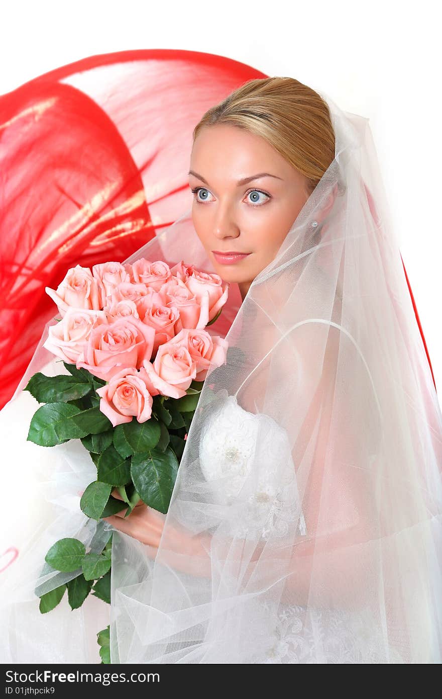 Beautiful young blonde in a veil and roses in hands. Beautiful young blonde in a veil and roses in hands