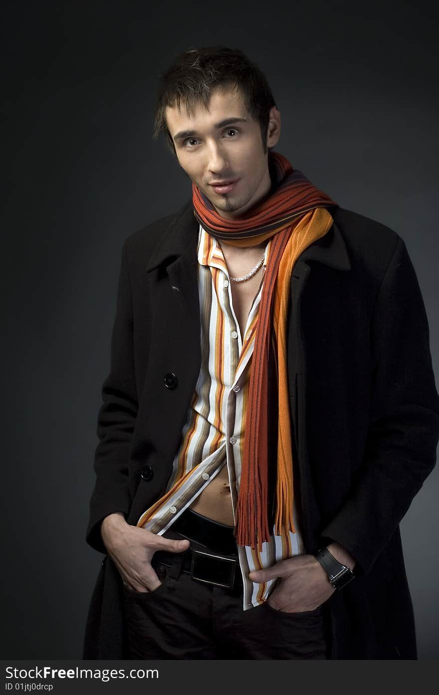 Portrait of a young business man with his hands on a dark background. Portrait of a young business man with his hands on a dark background