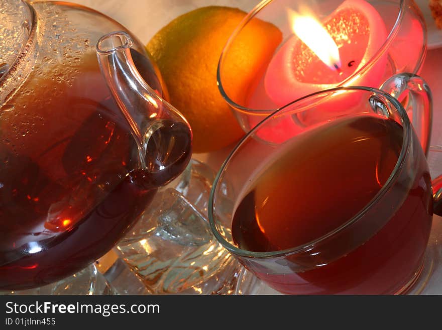 Teapot with cup of tea, jam and fruits. Teapot with cup of tea, jam and fruits.