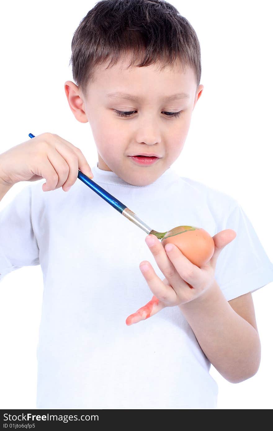 Little boy painting easter egg isolated on white