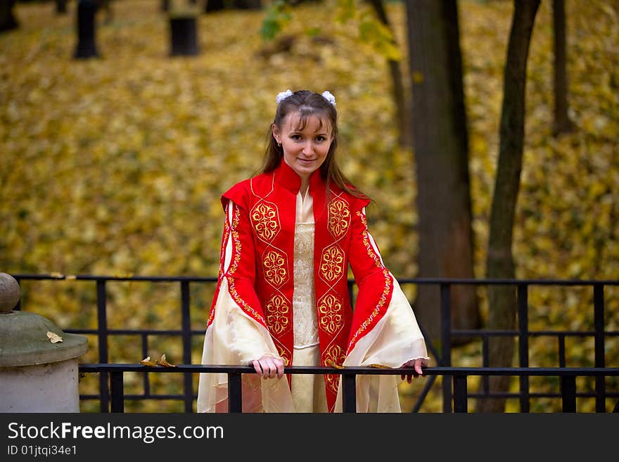 Lady in medieval red dress in the autumn forest. Lady in medieval red dress in the autumn forest