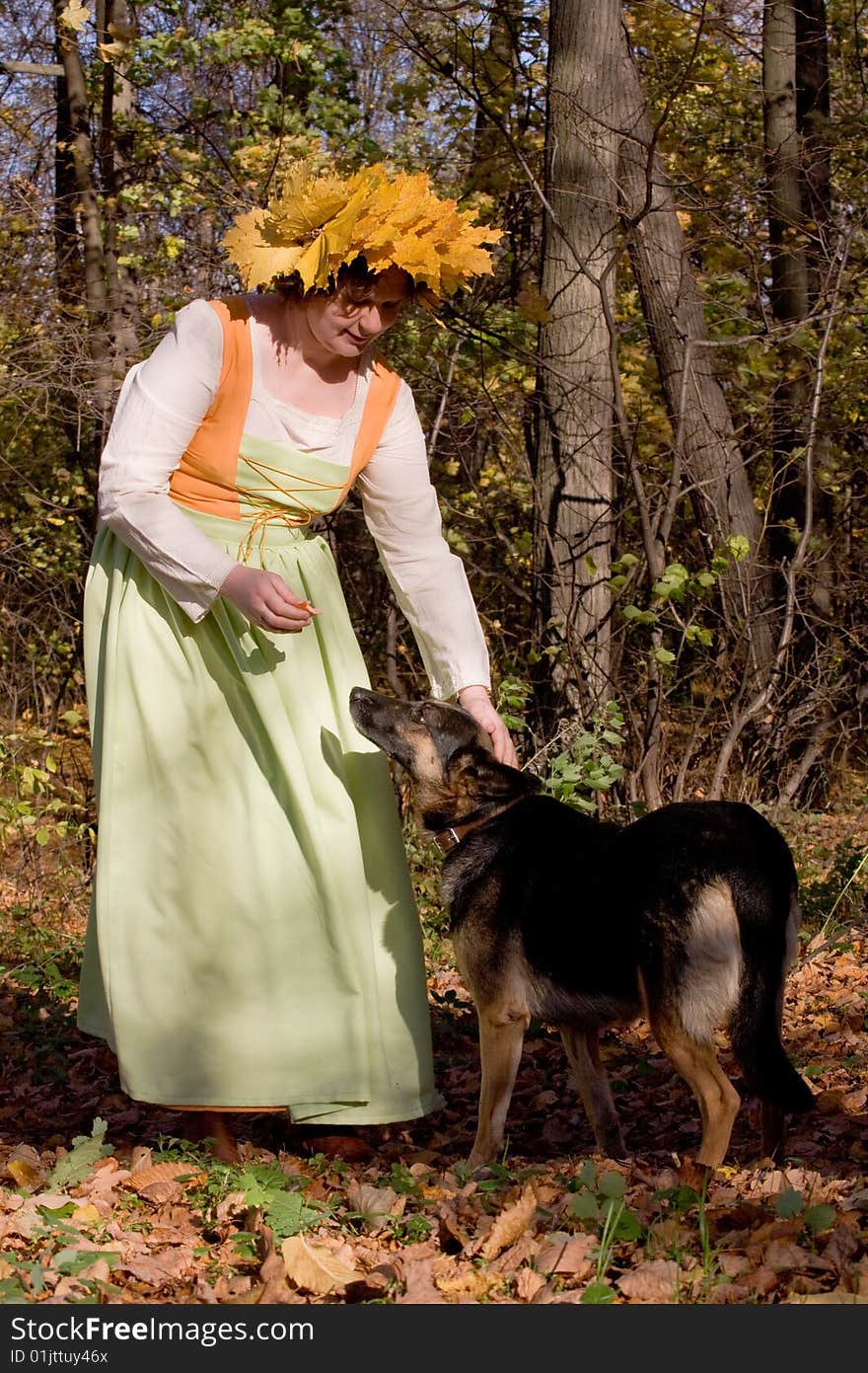 Woman and dog in autumn forest