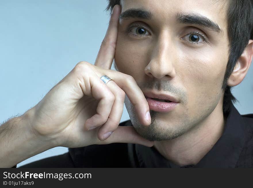 Handsome young man portrait in black suit in studio