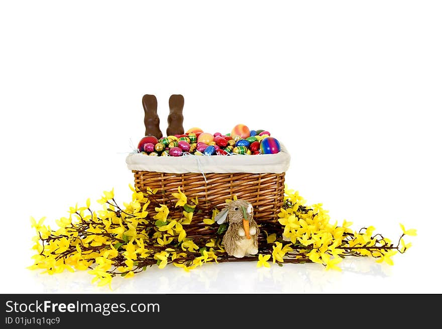 Basket with boiled and chocolate Easter eggs on white background, reflective surface. Basket with boiled and chocolate Easter eggs on white background, reflective surface