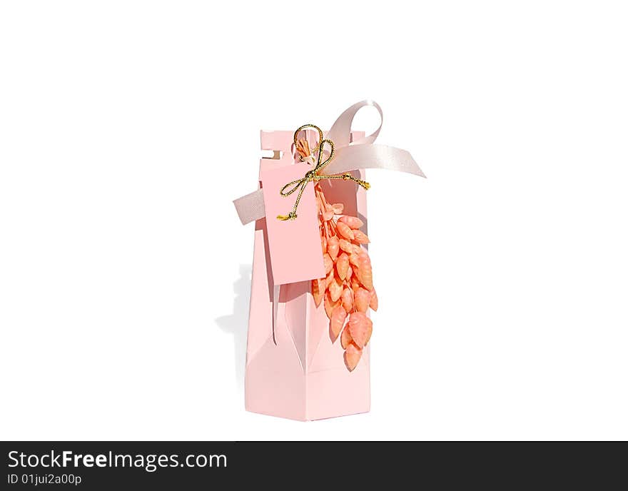 Pink gift box isolated over white whith clipping path. Blank pink tag is included so you can write who the present is for. Pink gift box isolated over white whith clipping path. Blank pink tag is included so you can write who the present is for.