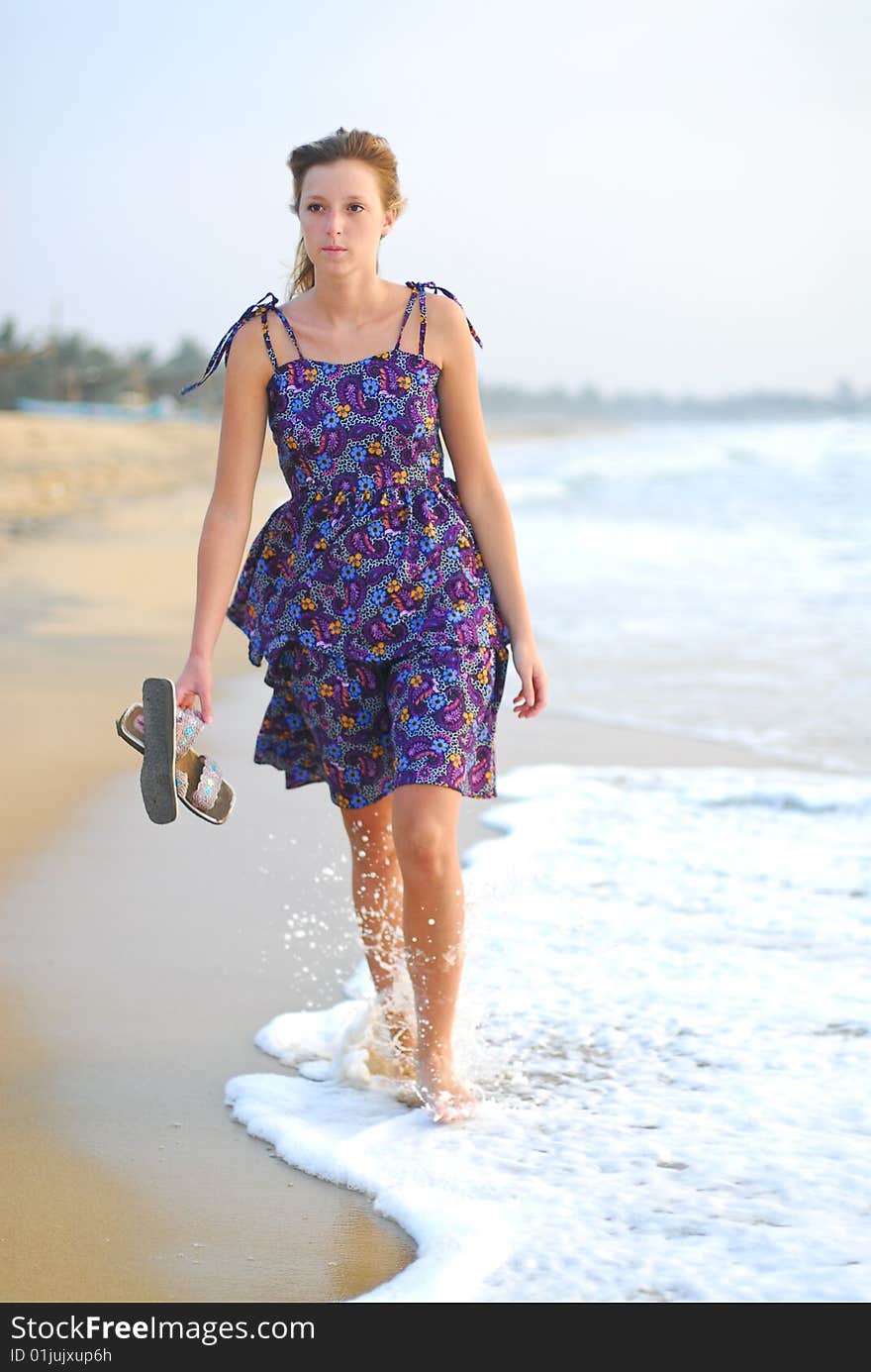 Beautiful Young Blond Girl Walking On Beach