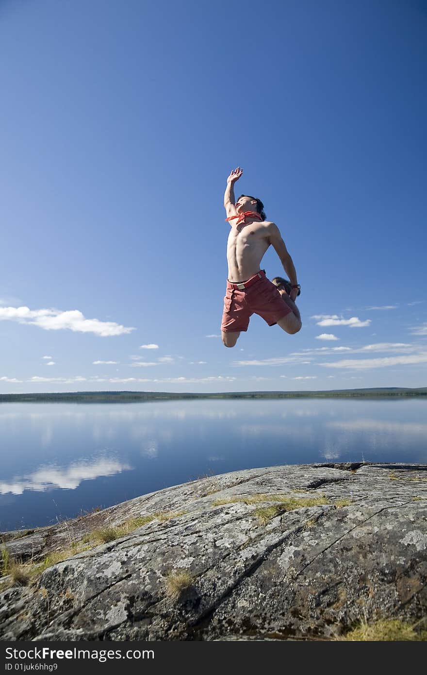 Young man jumping on a rock