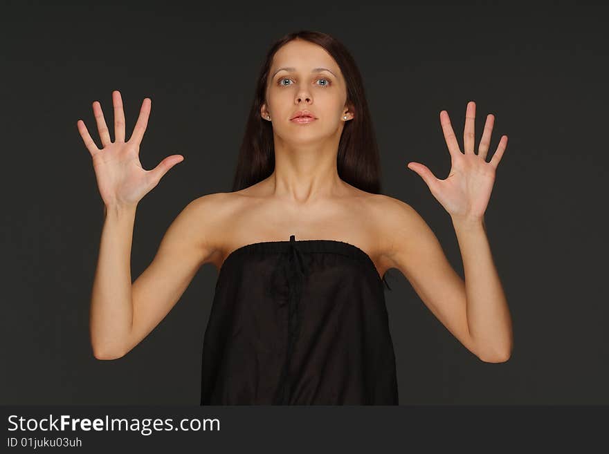 The young lonely woman on a dark background. The young lonely woman on a dark background