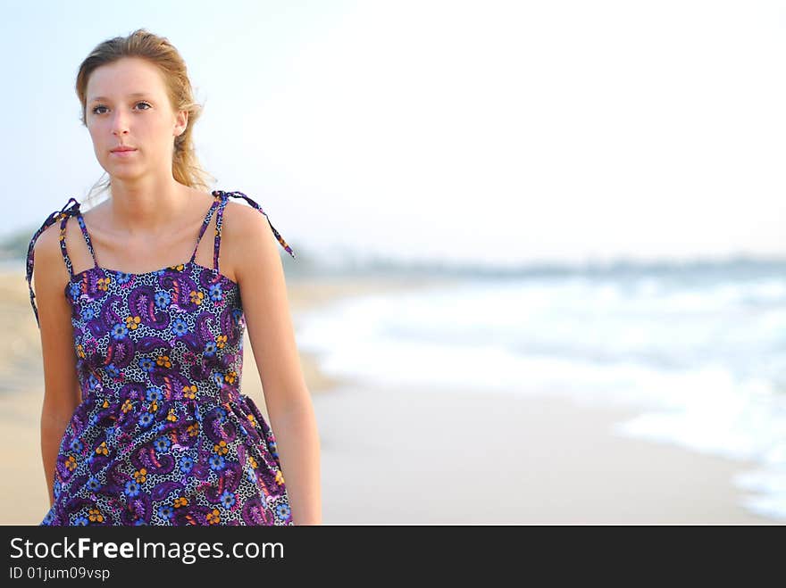 Beautiful Young Blond Girl Walking On Beach