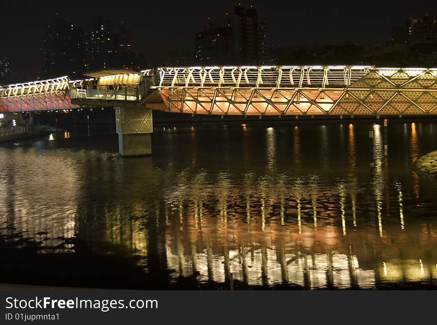 A neon bridge snakes over the Love River in Kaohsiung, Taiwan.