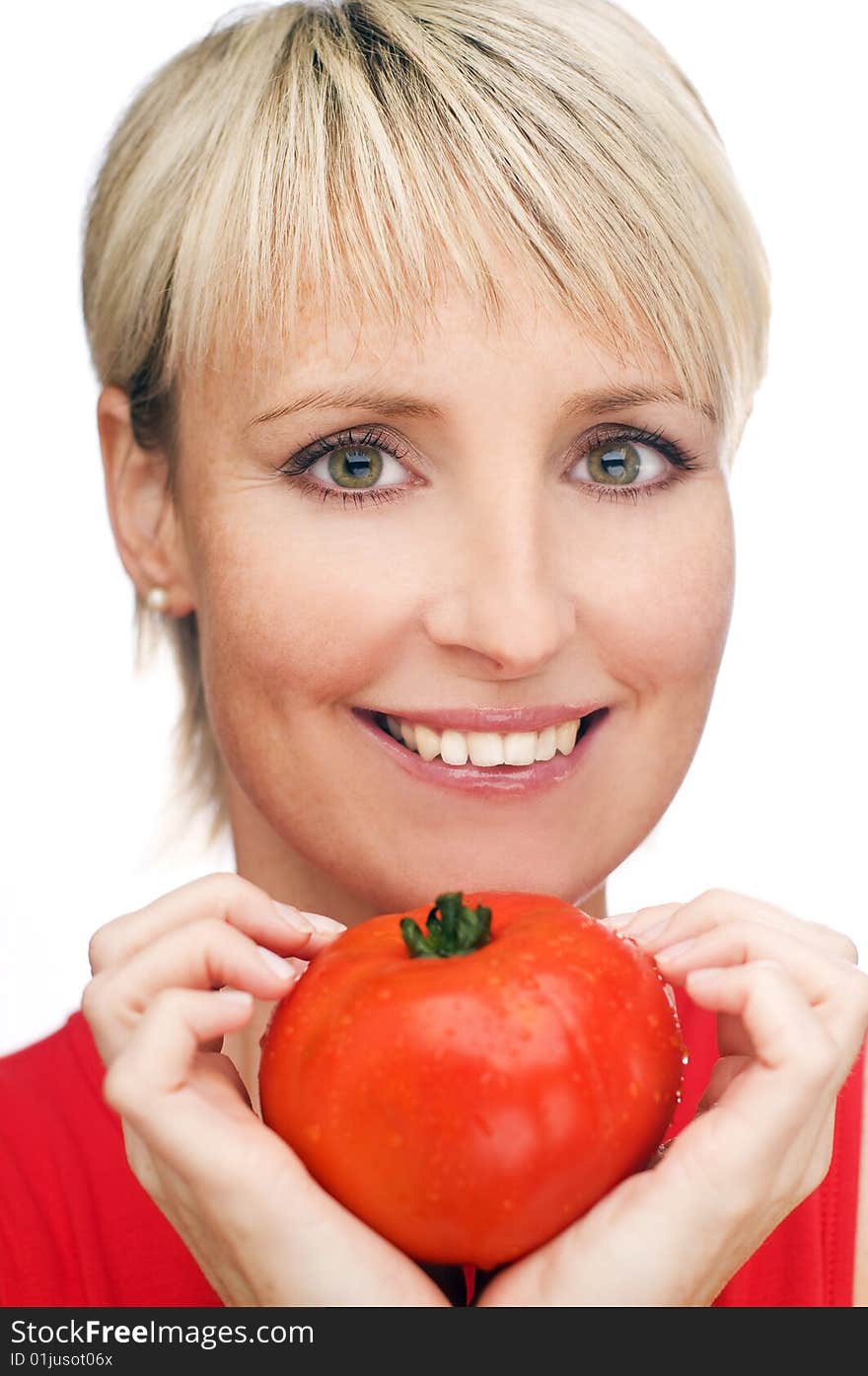 Blond girl with a ripe red tomato